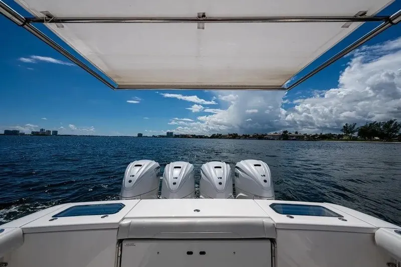  Yacht Photos Pics 2019 Everglades 435 Center Console boat with four engines on open water.