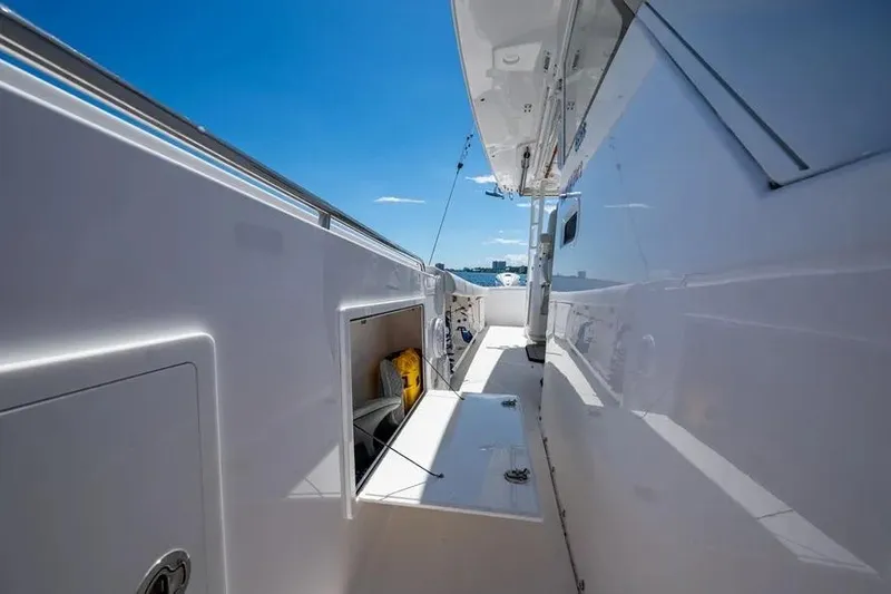  Yacht Photos Pics 2019 Everglades 435 Center Console boat deck with storage compartments, under clear blue sky.