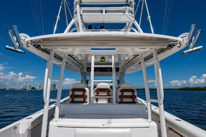  Yacht Photos Pics 2019 Everglades 435 Center Console boat on water, showcasing helm and seating area.