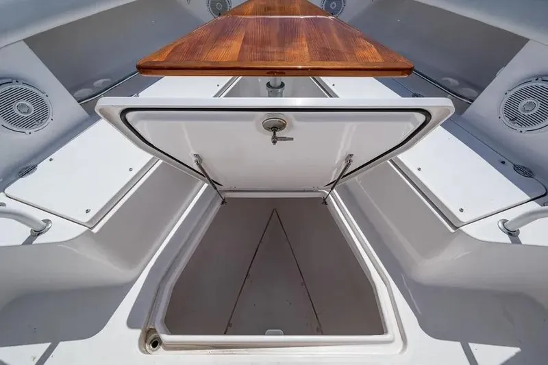  Yacht Photos Pics Open storage compartment on 2019 Everglades 435 Center Console boat with wooden table.