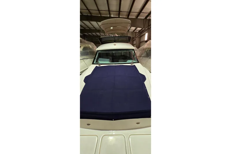 Your So Vein Yacht Photos Pics 2024 Regal 42 Fly yacht with blue cover in indoor storage.