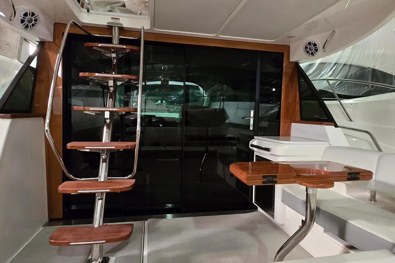 Your So Vein Yacht Photos Pics 2024 Regal 42 Fly yacht interior with wooden stairs and seating area.