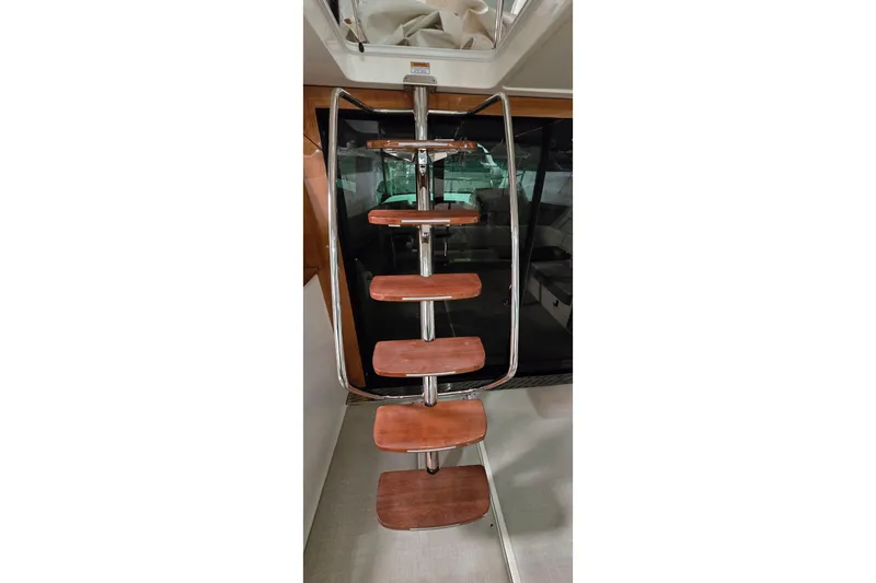 Your So Vein Yacht Photos Pics Staircase on 2024 Regal 42 Fly yacht with wooden steps and metal railing.