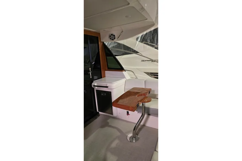 Your So Vein Yacht Photos Pics 2024 Regal 42 Fly yacht interior with sleek wooden table and modern seating area.