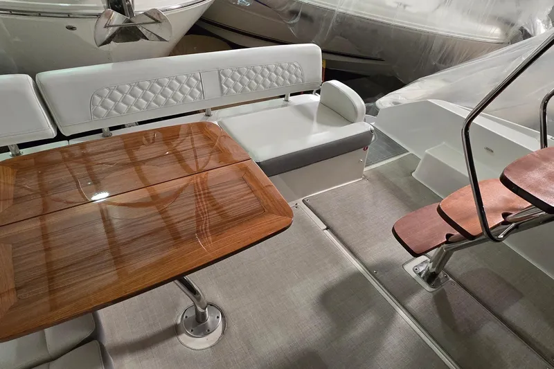 Your So Vein Yacht Photos Pics 2024 Regal 42 Fly yacht interior with elegant seating and wooden table.