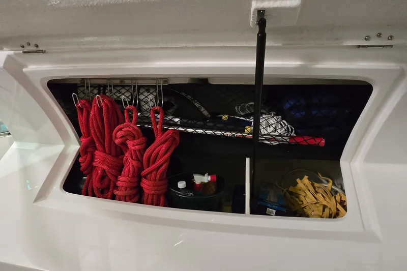 Your So Vein Yacht Photos Pics Storage compartment on 2024 Regal 42 Fly boat with red ropes and supplies.