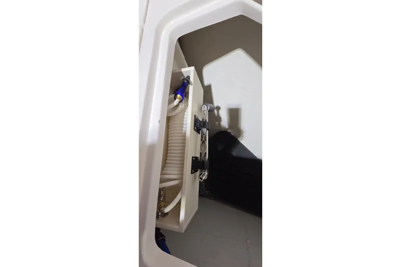 Your So Vein Yacht Photos Pics 2024 Regal 42 Fly yacht interior compartment with visible hoses and fittings.