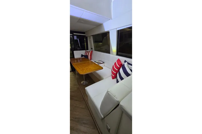 Your So Vein Yacht Photos Pics Luxurious interior of 2024 Regal 42 Fly yacht with elegant seating and striped cushions.