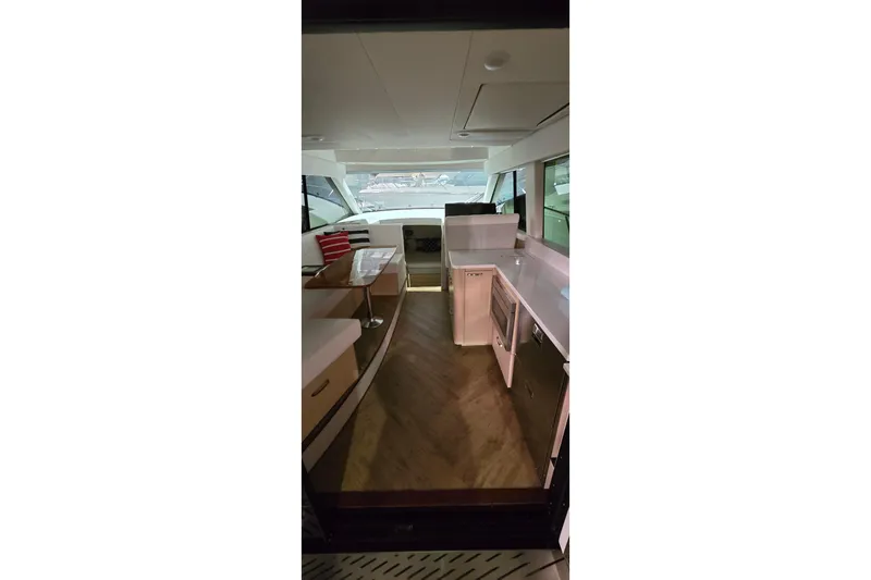 Your So Vein Yacht Photos Pics Interior of 2024 Regal 42 Fly yacht, featuring modern kitchen and seating area.