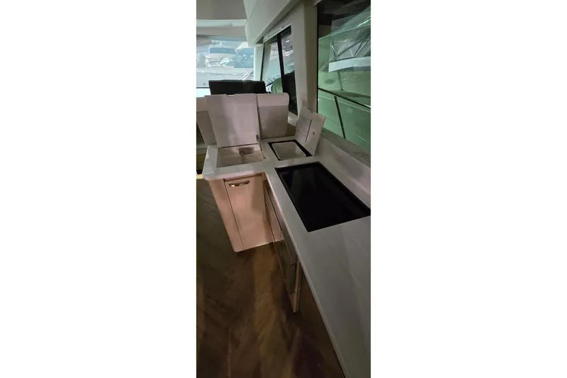 Your So Vein Yacht Photos Pics Modern kitchen area on 2024 Regal 42 Fly yacht, featuring sleek countertops and appliances.