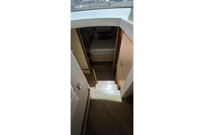 Your So Vein Yacht Photos Pics Interior view of 2024 Regal 42 Fly yacht cabin with stairs and bed.