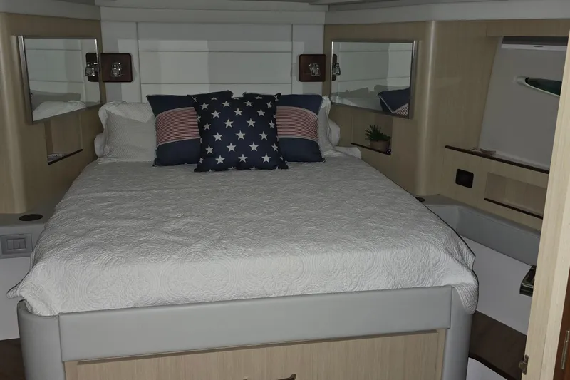 Your So Vein Yacht Photos Pics Luxurious bedroom interior of 2024 Regal 42 Fly yacht with elegant bedding and decor.