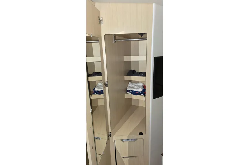 Your So Vein Yacht Photos Pics 2024 Regal 42 Fly yacht interior closet with shelves and hanging space.