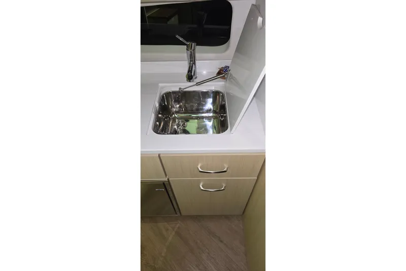 Your So Vein Yacht Photos Pics Modern kitchen sink in 2024 Regal 42 Fly yacht, featuring sleek design and cabinetry.