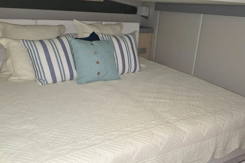 Your So Vein Yacht Photos Pics Luxurious bedroom interior of 2024 Regal 42 Fly yacht with stylish pillows and bedding.