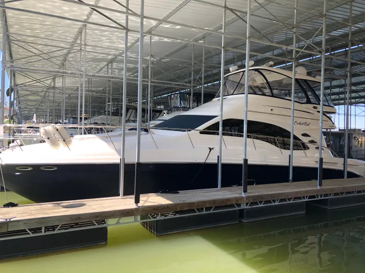 Cashed Out Yacht Photos Pics 2006 Sea Ray 58 Sedan Bridge yacht docked in a covered marina.