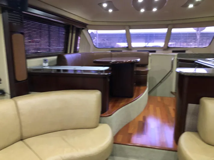 Cashed Out Yacht Photos Pics Luxurious interior of 2006 Sea Ray 58 Sedan Bridge yacht with elegant seating and wood flooring.