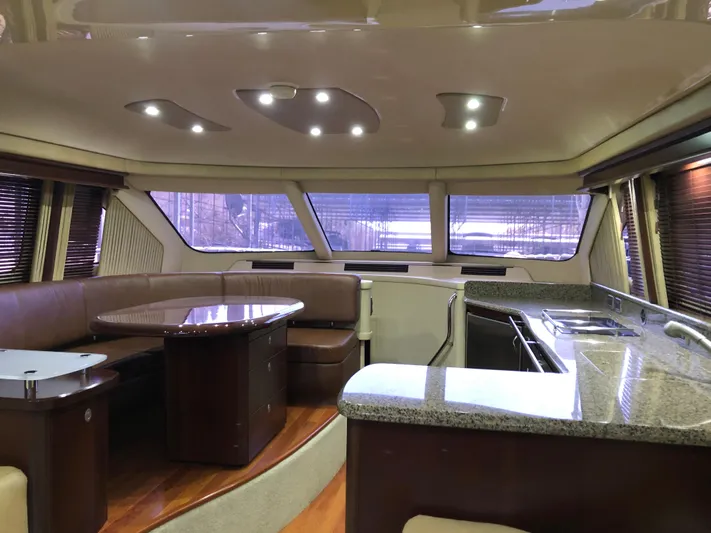 Cashed Out Yacht Photos Pics Luxurious interior of 2006 Sea Ray 58 Sedan Bridge yacht with modern kitchen and seating area.