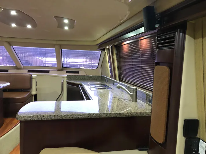 Cashed Out Yacht Photos Pics Luxurious interior of 2006 Sea Ray 58 Sedan Bridge yacht with modern kitchen amenities.