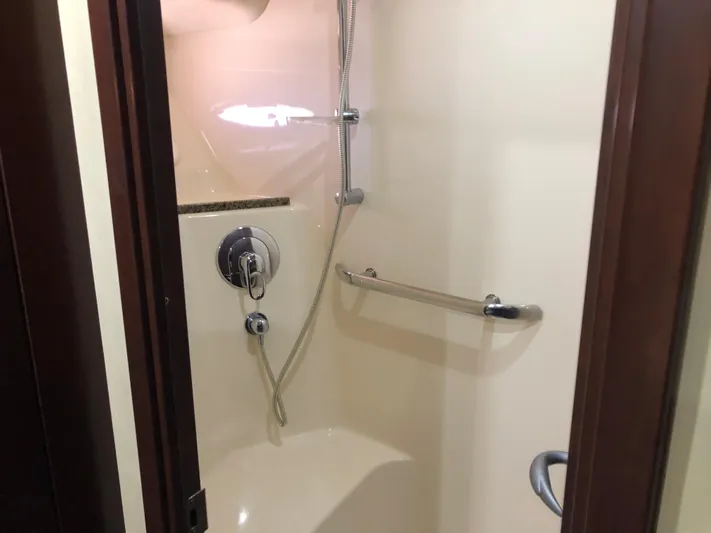 Cashed Out Yacht Photos Pics Shower area in 2006 Sea Ray 58 Sedan Bridge yacht, featuring modern fixtures and grab bar.