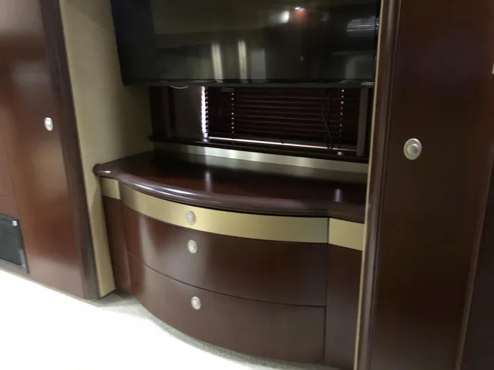 Cashed Out Yacht Photos Pics Luxurious interior of 2006 Sea Ray 58 Sedan Bridge with elegant wood cabinetry and TV.