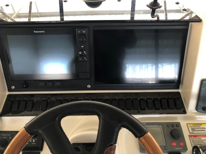 Cashed Out Yacht Photos Pics 2006 Sea Ray 58 Sedan Bridge helm with dual navigation screens and steering wheel.