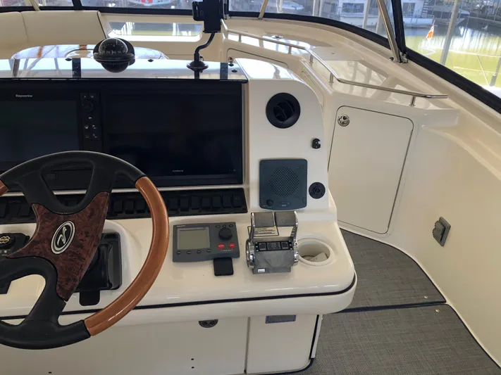 Cashed Out Yacht Photos Pics 2006 Sea Ray 58 Sedan Bridge helm with steering wheel and navigation controls.