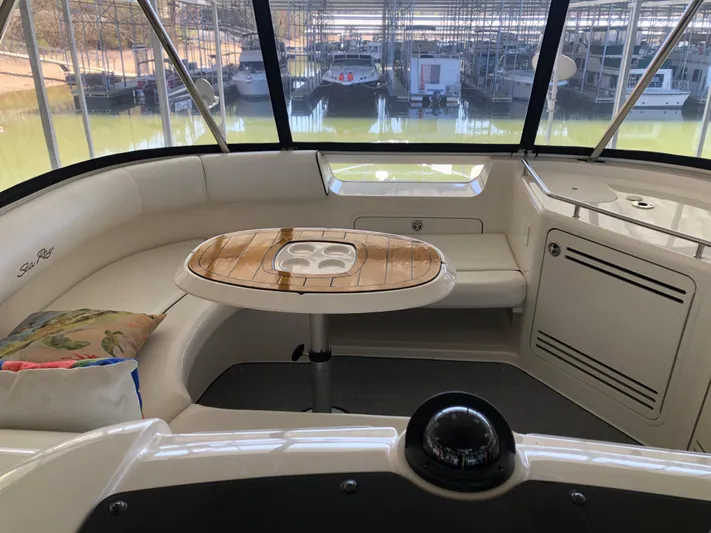 Cashed Out Yacht Photos Pics 2006 Sea Ray 58 Sedan Bridge interior with seating and wooden table.