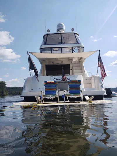 Cashed Out Yacht Photos Pics 2006 Sea Ray 58 Sedan Bridge yacht on water with deck chairs and flags.