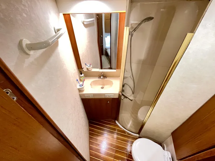  Yacht Photos Pics Bathroom interior of 2000 Ocean Yachts 43 Super Sport with shower, sink, and toilet.