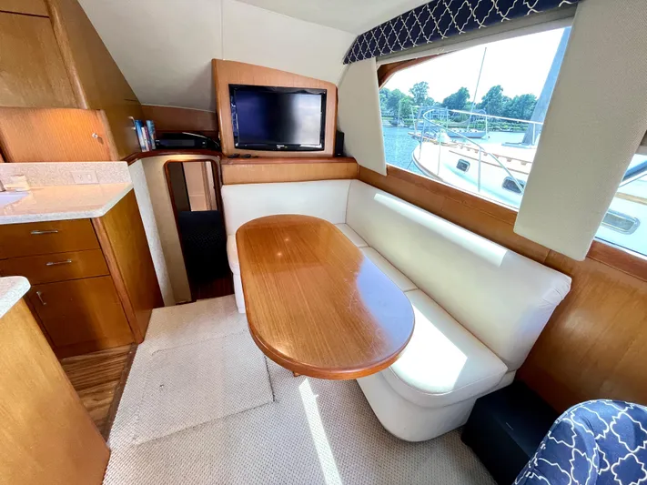  Yacht Photos Pics Interior of 2000 Ocean Yachts 43 Super Sport with dining area and TV.