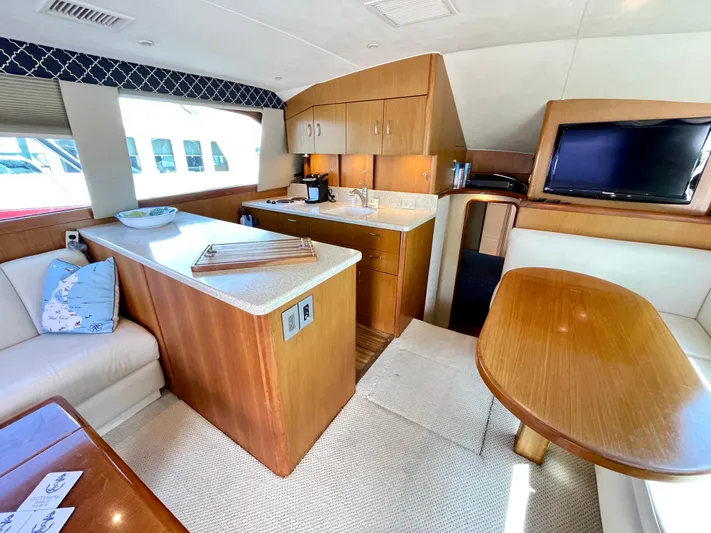  Yacht Photos Pics Luxurious interior of 2000 Ocean Yachts 43 Super Sport with kitchen and seating area.