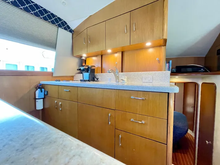  Yacht Photos Pics Interior of 2000 Ocean Yachts 43 Super Sport, featuring a modern kitchen with wood cabinetry.