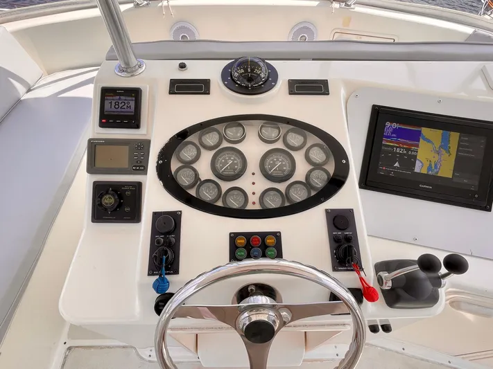  Yacht Photos Pics Control panel of 2000 Ocean Yachts 43 Super Sport with navigation instruments and steering wheel.