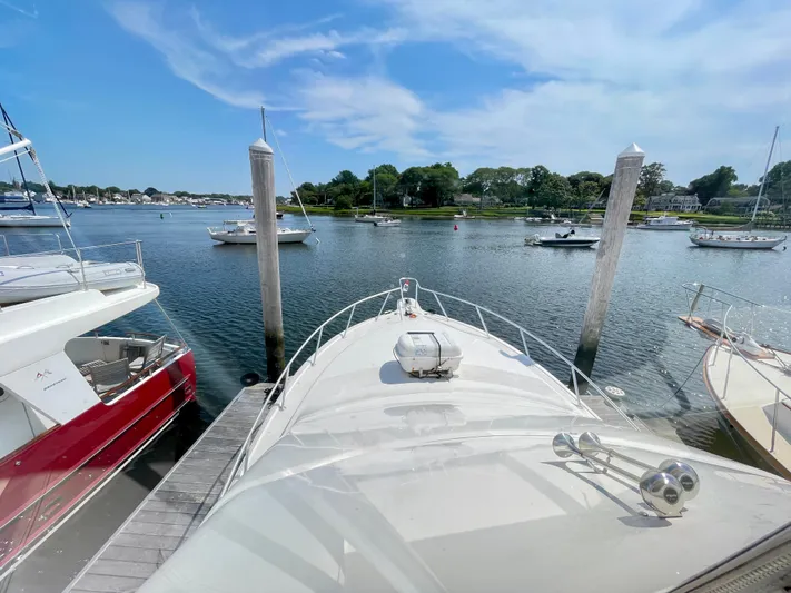  Yacht Photos Pics Ocean Yachts 43 Super Sport 2000 docked in a scenic marina with clear skies.