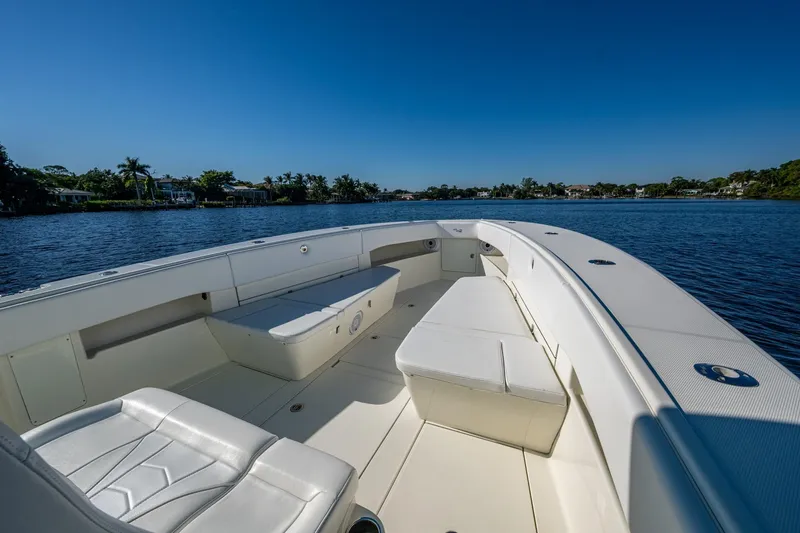  Yacht Photos Pics 2017 SeaVee 390Z boat interior with white seating, on calm water under clear blue sky.