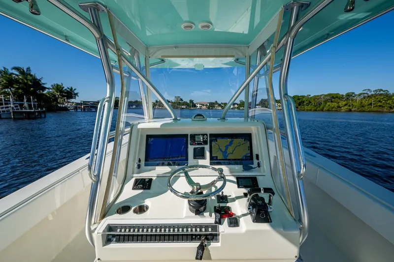  Yacht Photos Pics 2017 SeaVee 390Z boat cockpit with navigation screens, steering wheel, and controls on a sunny day.
