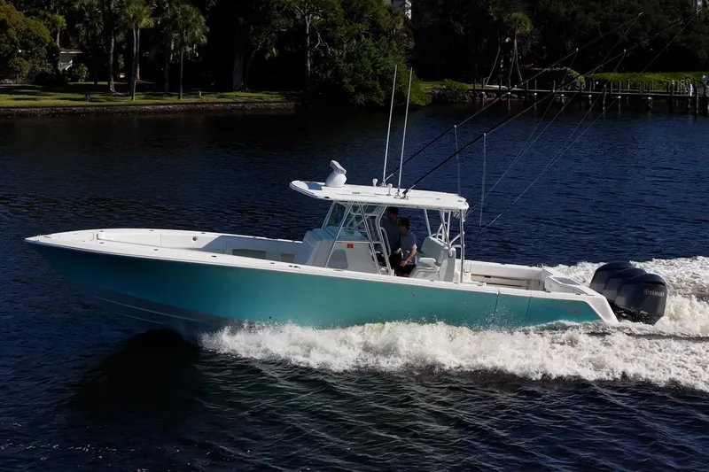  Yacht Photos Pics 2017 SeaVee 390Z boat cruising on a river with lush greenery in the background.