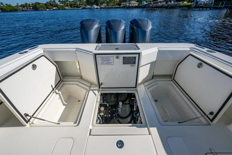  Yacht Photos Pics 2017 SeaVee 390Z boat with open storage compartments and triple outboard engines.