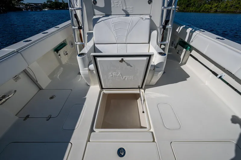  Yacht Photos Pics 2017 SeaVee 390Z boat deck with open storage compartment, white seating, and water view.
