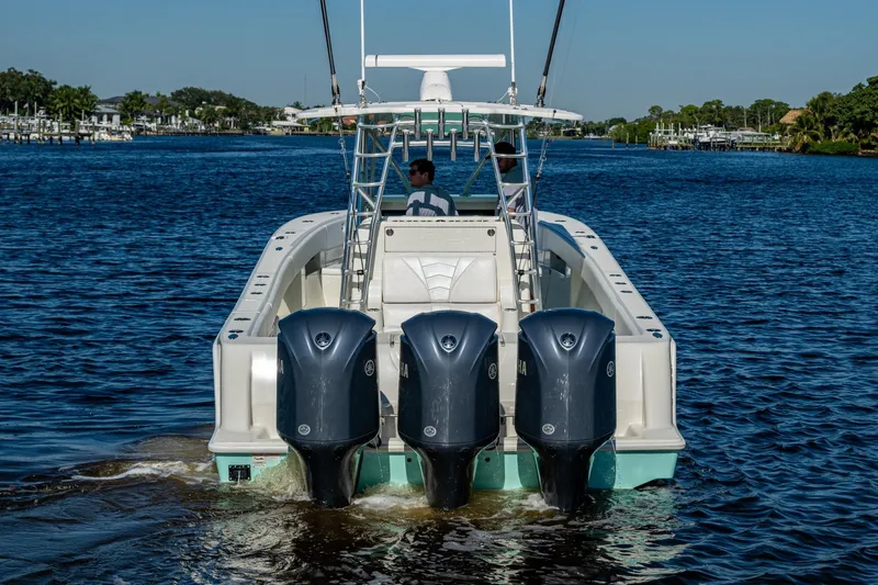  Yacht Photos Pics 2017 SeaVee 390Z boat with triple Yamaha engines on a calm waterway.