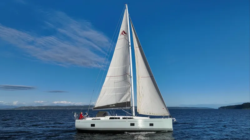 Dragon Fly Yacht Photos Pics 2019 Hanse 418 sailboat cruising on open water under clear blue skies.