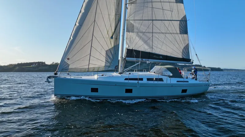 Dragon Fly Yacht Photos Pics 2019 Hanse 418 sailboat cruising on open water under clear blue skies.