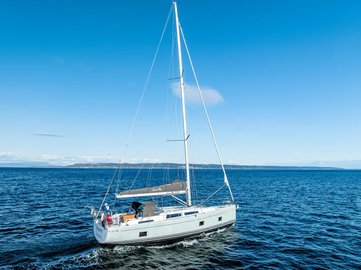 Dragon Fly Yacht Photos Pics 2019 Hanse 418 sailboat cruising on open blue sea under clear sky.