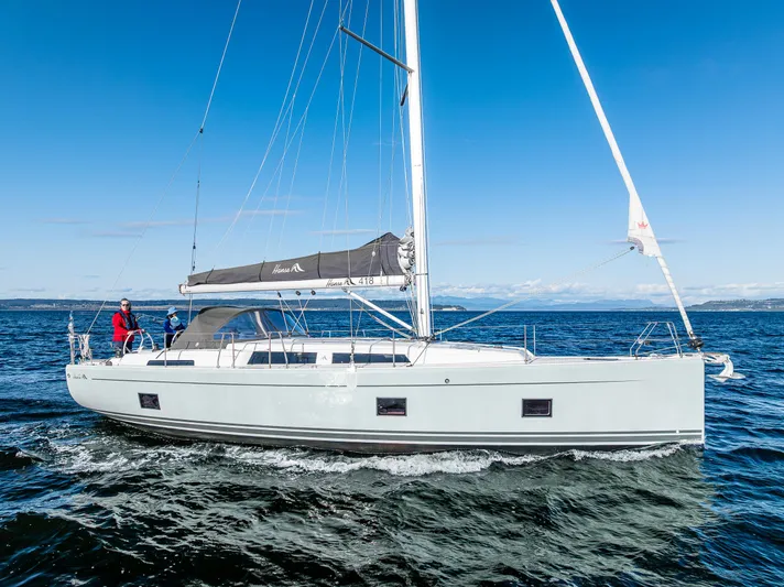 Dragon Fly Yacht Photos Pics 2019 Hanse 418 sailboat cruising on open water under clear blue skies.