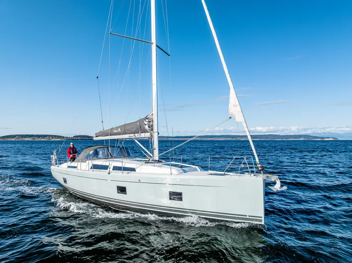 Dragon Fly Yacht Photos Pics 2019 Hanse 418 sailboat cruising on open water under clear blue skies.