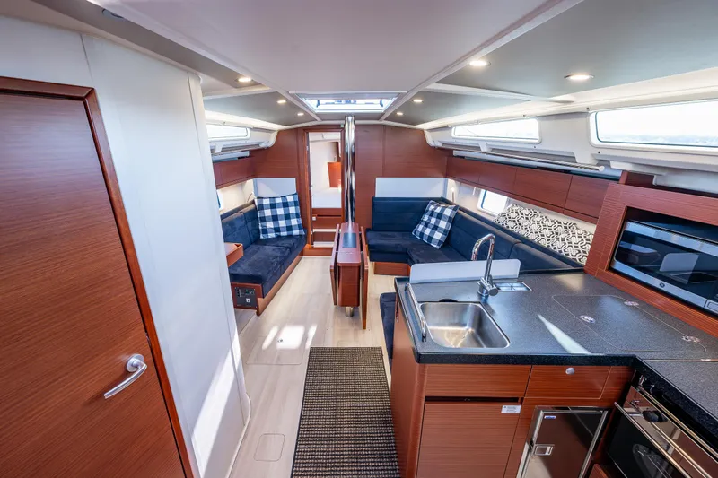 Dragon Fly Yacht Photos Pics Interior of 2019 Hanse 418 yacht with modern kitchen and seating area.