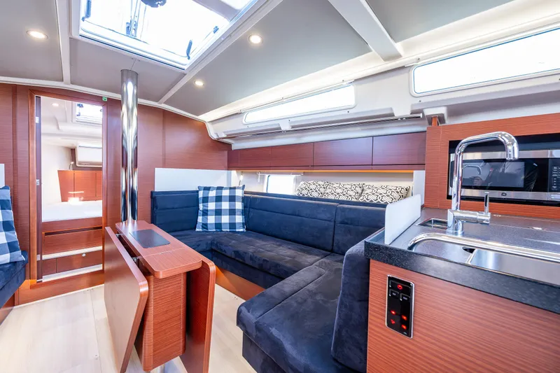 Dragon Fly Yacht Photos Pics Interior of 2019 Hanse 418 yacht with modern kitchen and cozy seating area.