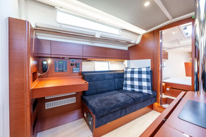 Dragon Fly Yacht Photos Pics 2019 Hanse 418 yacht interior with modern wood finish and cozy seating area.