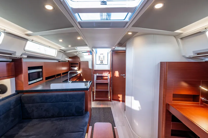Dragon Fly Yacht Photos Pics Luxurious interior of 2019 Hanse 418 yacht with modern wood finishes and skylight.